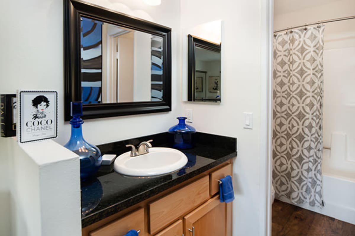 A bathroom with b lack counter top at River Ranch, Simi Valley, California