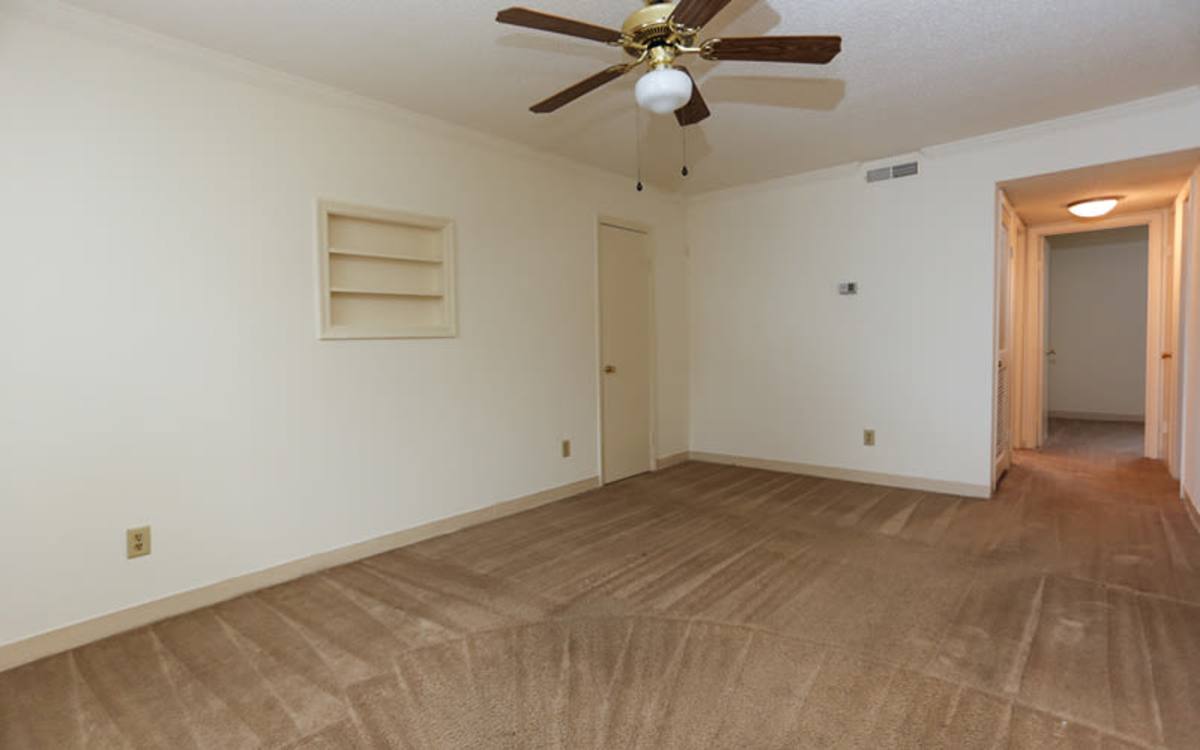 Model living room with ceiling fan at Landmark Apartments in Chesapeake, Virginia