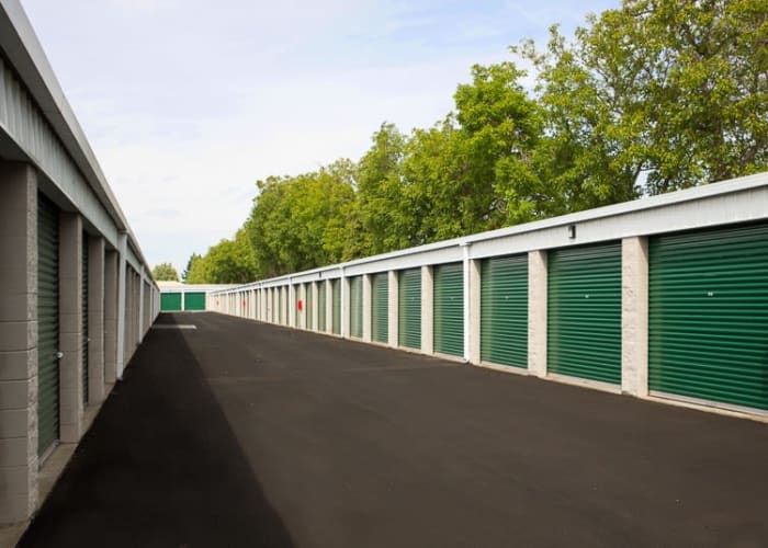 Outdoor storage units with green doors and wide driveways at A Storage Place in Keizer, Oregon