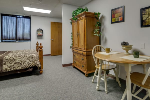 Assisted living apartment bedroom and dining room at SummitView Terrace in Kansas City, Missouri