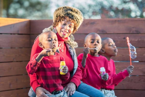 A resident with her grandchildren at at Wesley Place on Honeysuckle in Dothan, Alabama