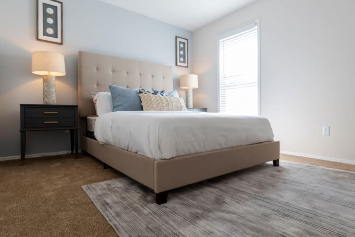 Apartment bedroom with a bright window at Webb Bridge Crossing in Alpharetta, Georgia
