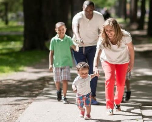 Happy family walking near East Ridge Manor Apartments in Rochester, New York