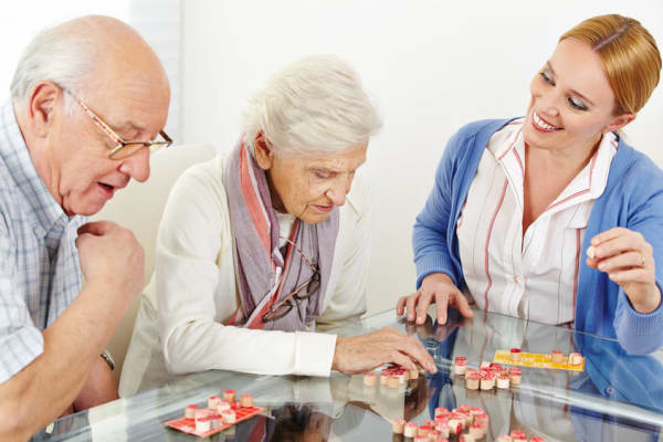 A nurse enjoying her job at Heritage Oaks Assisted Living and Memory Care in Englewood, Florida