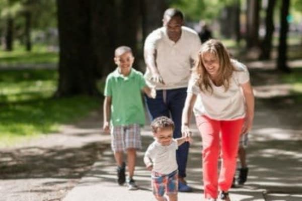 Family walking in Penfield, New York near Penbrooke Meadows