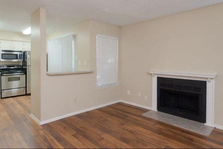 Wood-style floors with fireplace at The Regent in Dallas, Texas
