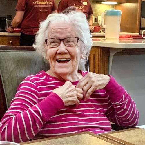 Resident smiling in a lounge at Glen Carr House Memory Care in Derby, Kansas