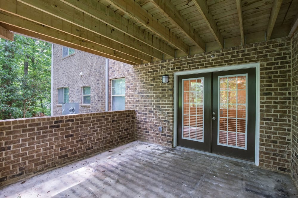 Beautiful covered brick deck at The Crossing at Henderson Mill Apartment Homes in Atlanta, Georgia