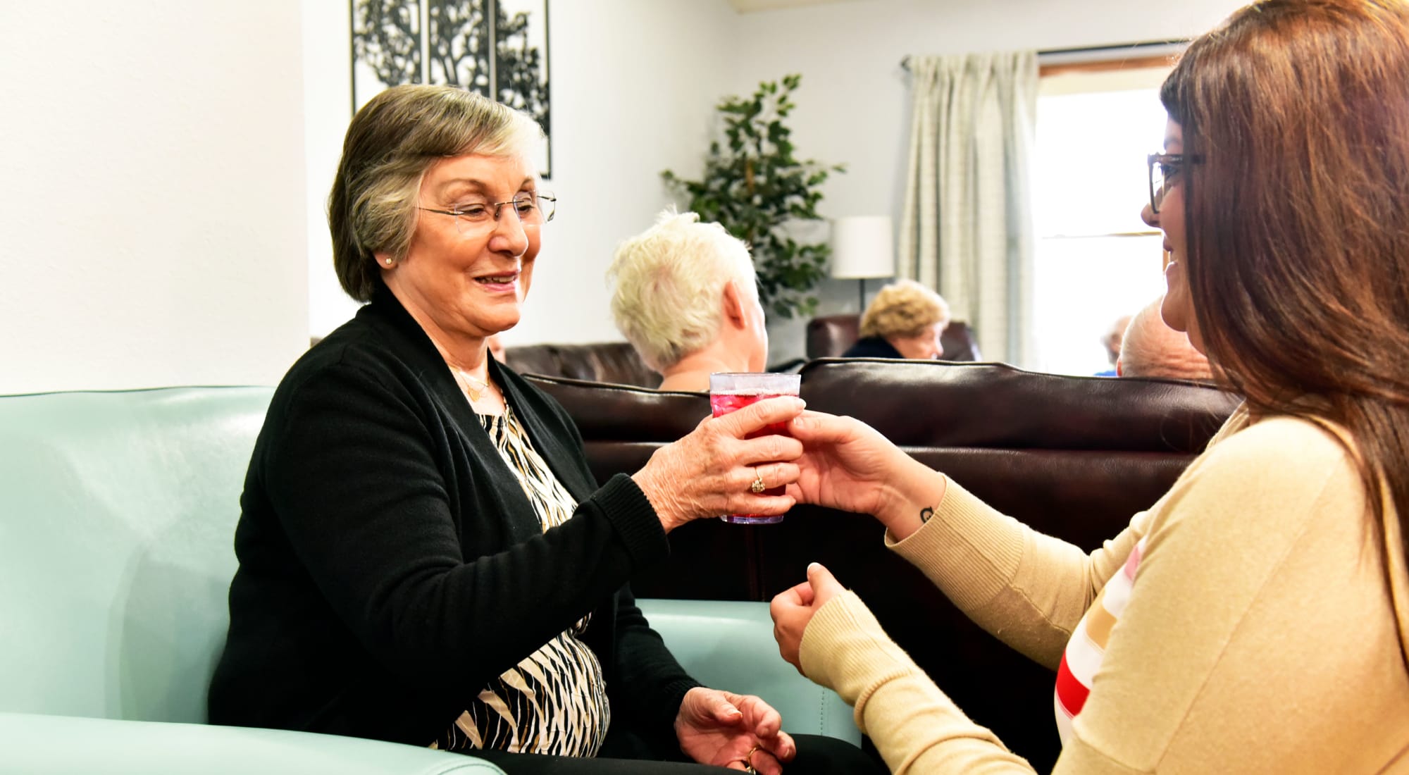 Resident mother enjoying a drink with daughter near Reflections at Garden Place