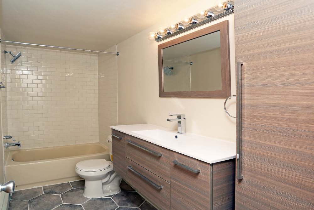 Bathroom with large mirror at Detroit Living in Detroit, Michigan