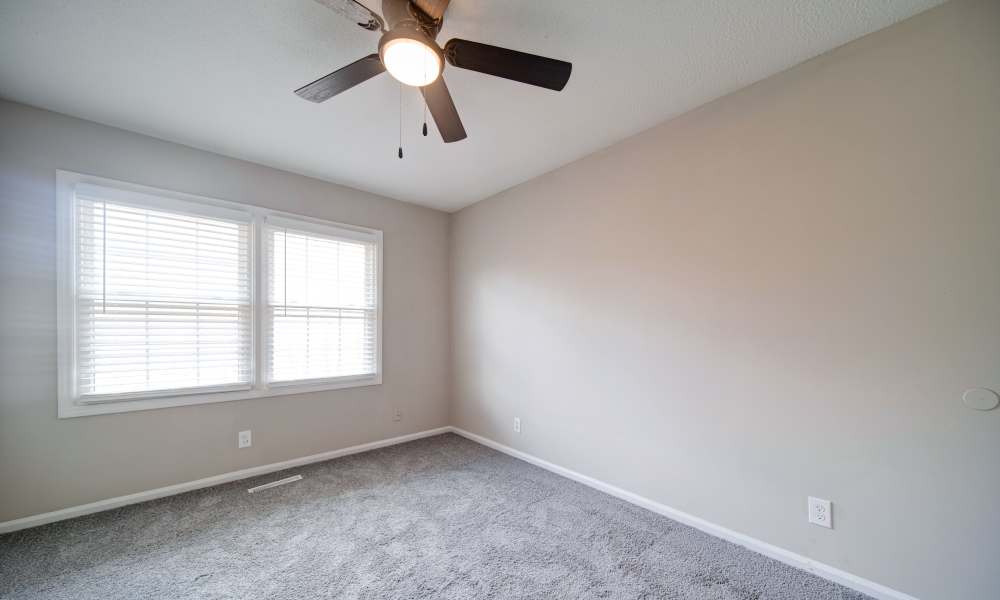 Modern bedroom with a window at The Manor Townhomes in Winston-Salem, North Carolina
