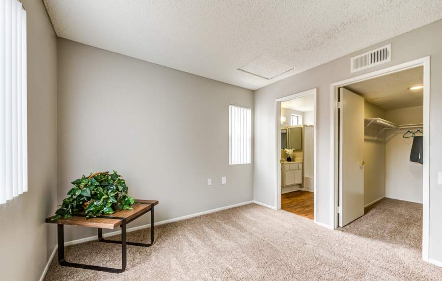 Carpet-floored bedroom with walk-in closet at The Villas at Rowland Heights in Rowland Heights, California