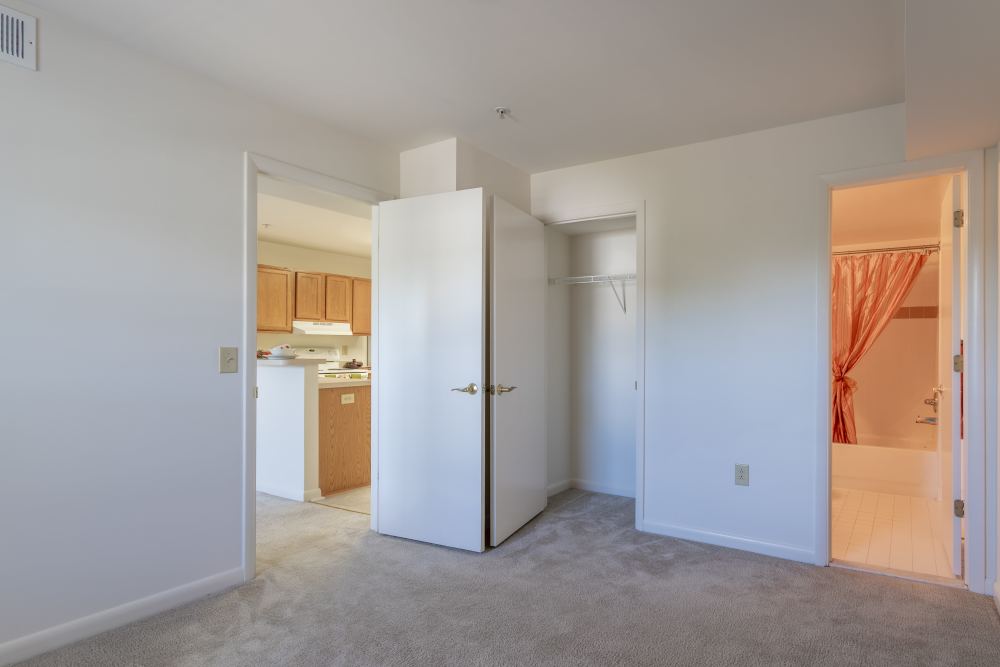 Master bedroom with access to bathromm at Corrigan Square Apartments in Gaithersburg, Maryland