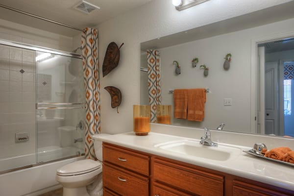 Model bathroom with wooden cabinetry at San Palacio in Chandler, Arizona