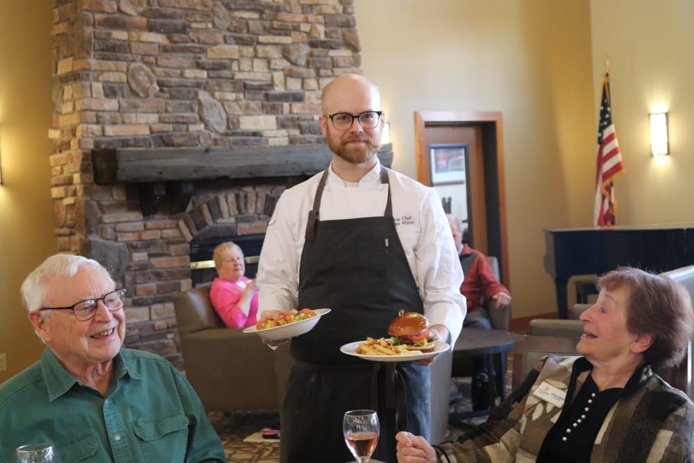 Residents being served dinner in dining room at The Springs at Missoula in Missoula, Montana.