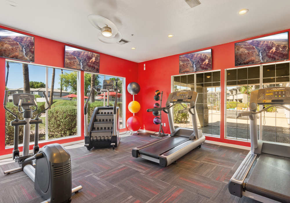 Spacious living room with red sofa and carpet at Luxe @ Ocotillo in Chandler, Arizona  