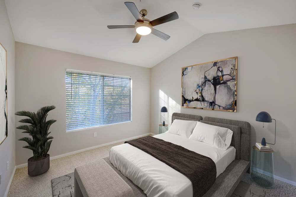 Bedroom with ceiling fan at The Crossings at Bear Creek Apartments in Lakewood, Colorado