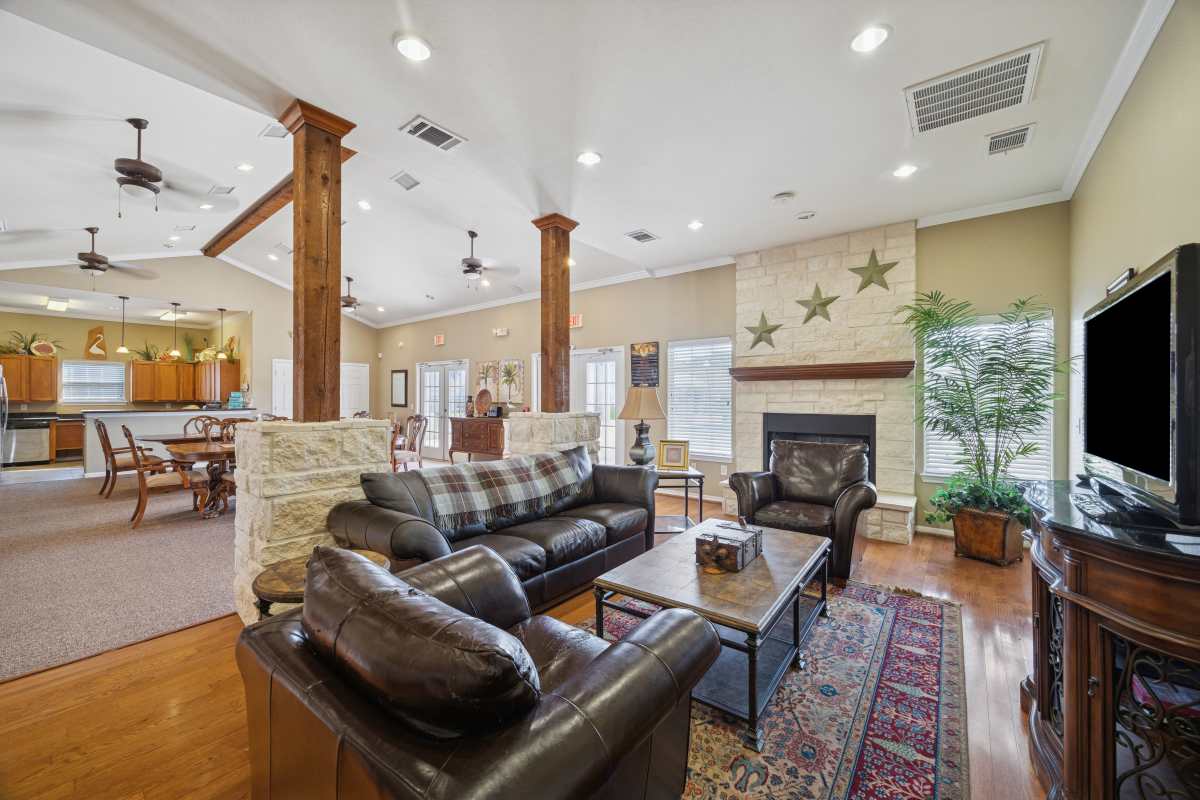 Clubhouse with fireplace and seating area at Palm Garden in Orange, Texas
