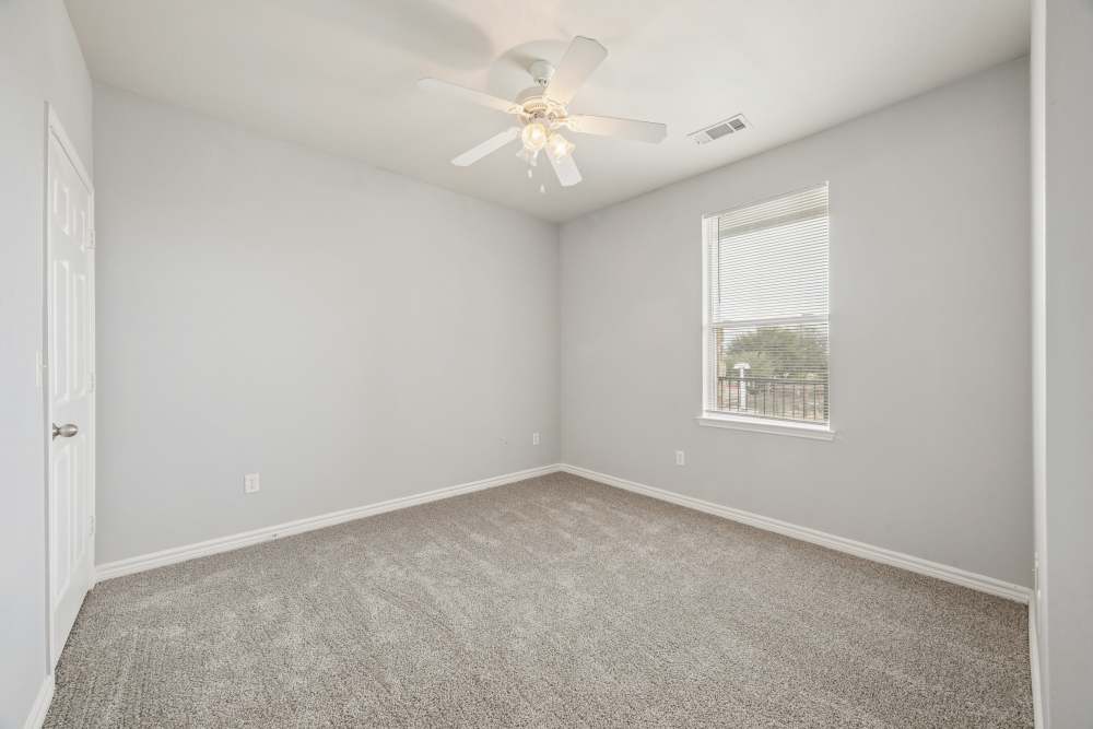 Bedroom with carpet flooring and window at The Cove at Palmer Point in Texas City, Texas