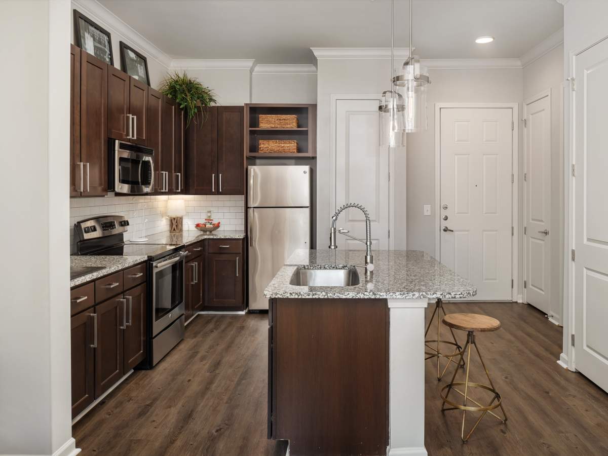 Gated kitchen with dark cabinets and granite countertops at Ardmore & Twenty Eighth in Atlanta, Georgia