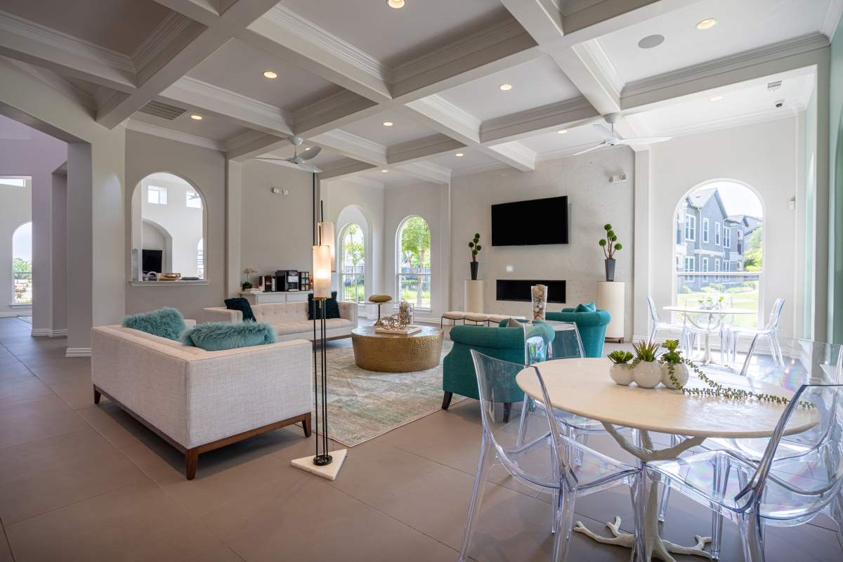 Spacious clubhouse with couch, chairs , dining table and flat screen television at Century Travesia in Austin, Texas