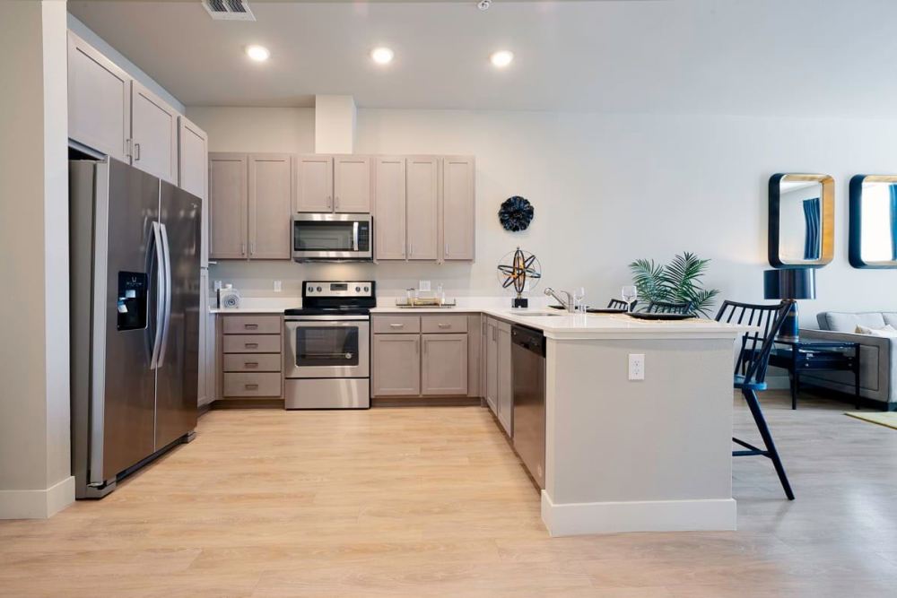 Kitchen with stainless steel appliances and island at BDX at Capital Village in Rancho Cordova, California