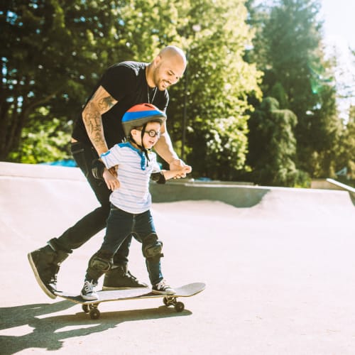 a father teaching their child to skate at Wadsworth Shores in Virginia Beach, Virginia