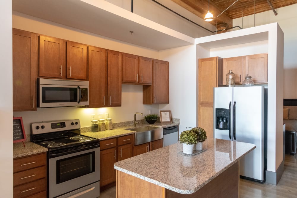 Spacious living room with large windows at Loray Mill Lofts in Gastonia, North Carolina