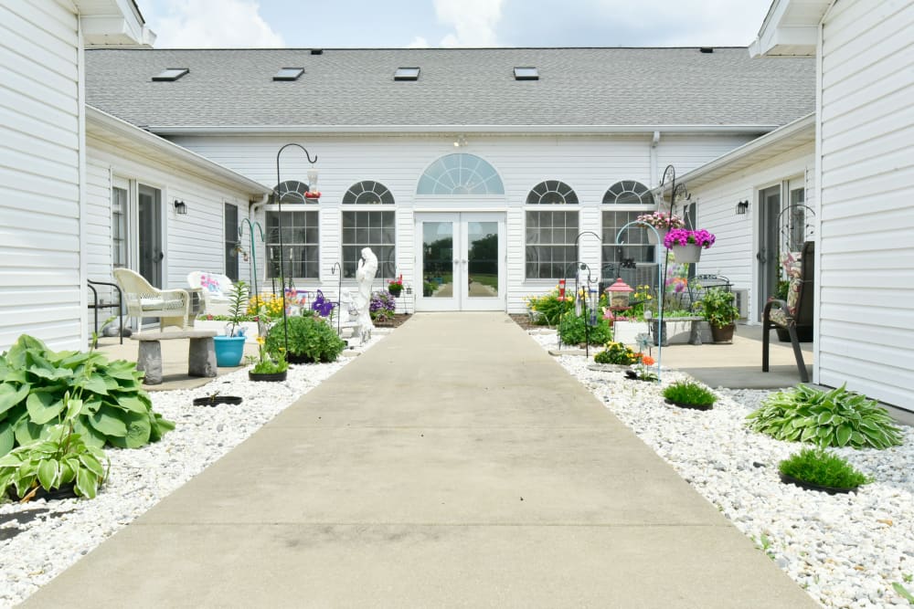 Outdoor courtyard with thriving plants at Garden Place Red Bud in Red Bud, Illinois