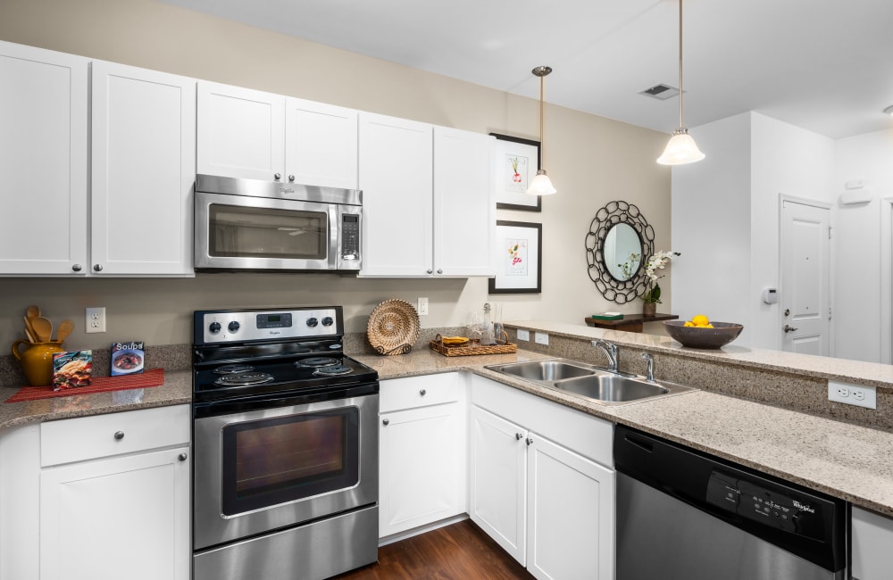 Kitchen with modern stainless-steel appliances at The Apartments at Spence Crossing, Virginia Beach, Virginia