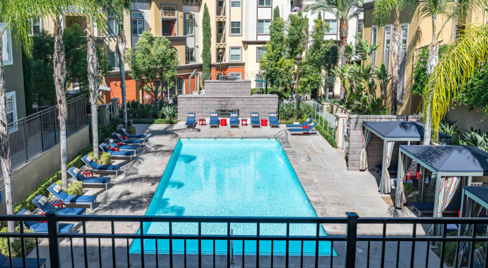 Pool with lounge chair and cabana at The Boulevard Apartment Homes in Woodland Hills, California