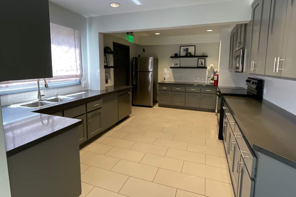 Spacious modern kitchen with dark cabinets at  Waterstone in Chatsworth, California