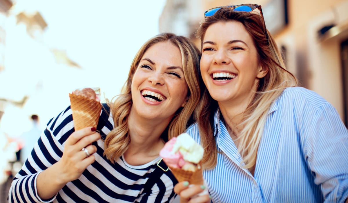 Two smiling women holding ice cream cones at The 603 in Bryan, Texas