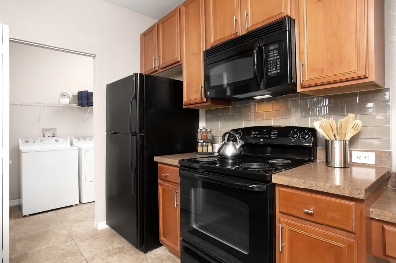 Kitchen with adjacent Washer and Dryer room at The Aspect in Kissimmee, Florida