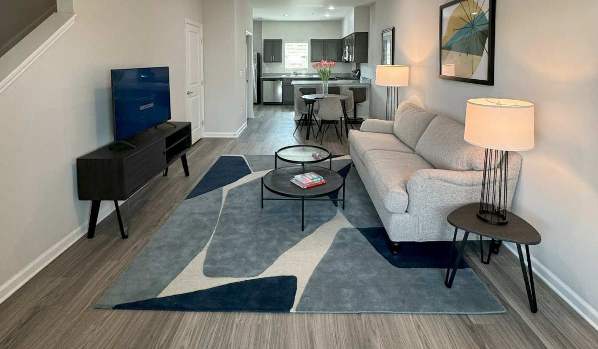 Spacious living room with large couch and side table lamp at Las Colinas in Foley, Alabama