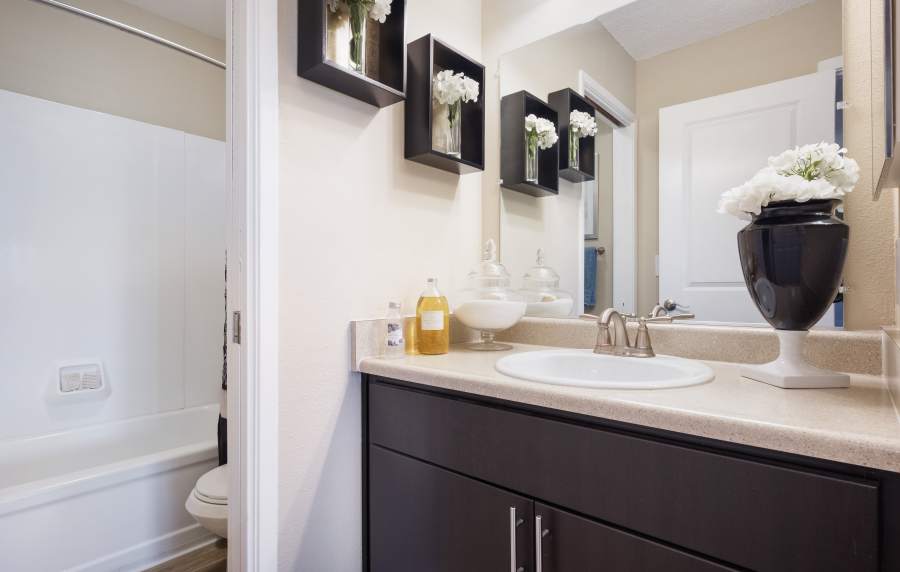 Modern bathroom with large mirror at Harbor Cove Apartments in Foster City, California