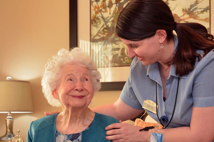 Happy resident with caregiver at BPM Senior Living