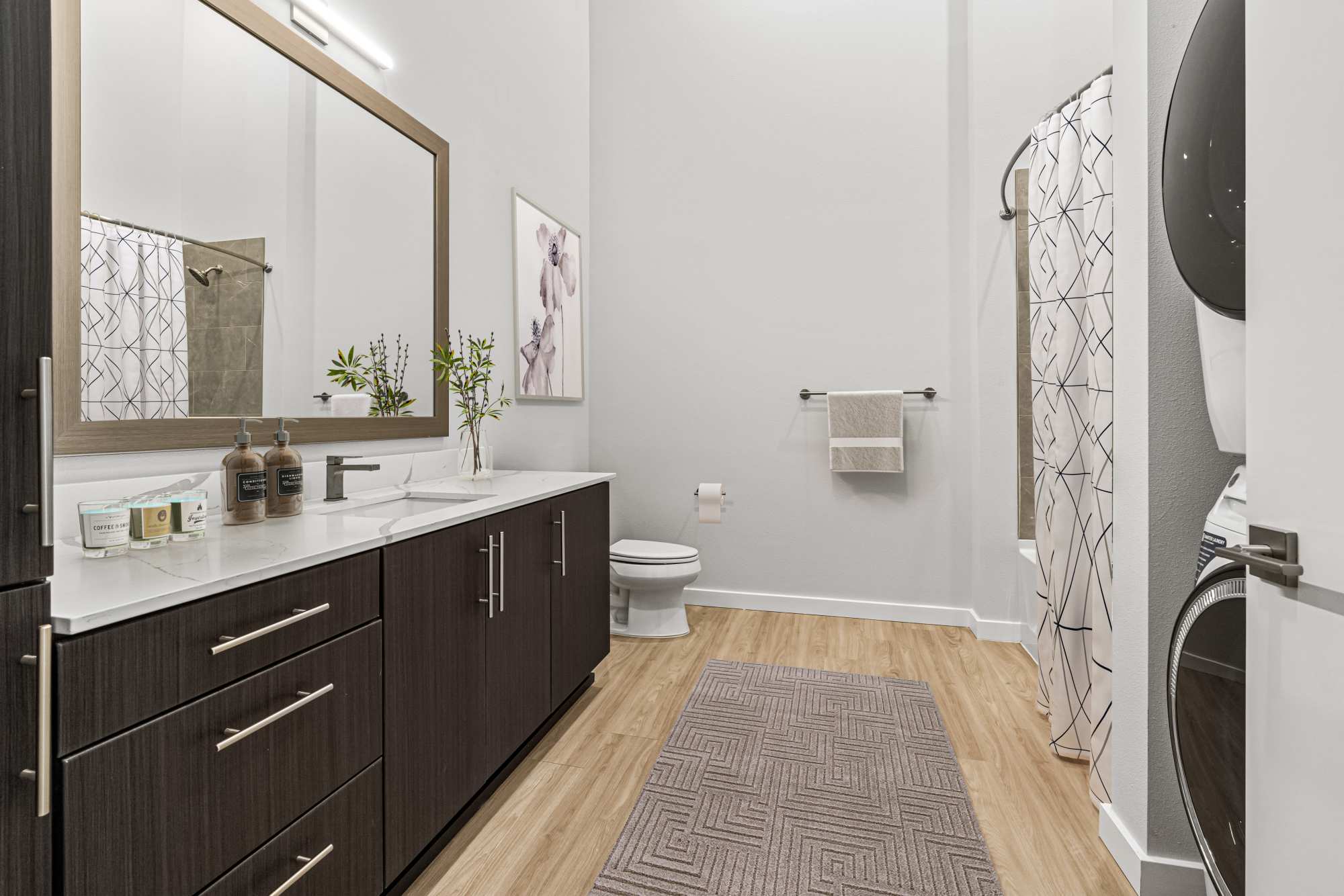 Bathroom with large vanity and wood-style flooring at The Highlands at Silverdale in Silverdale, Washington