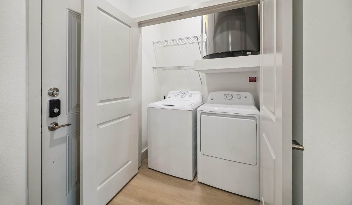 Studio washer and dryer in laundry closet at Dakota at Hillcroft in Houston, Texas 