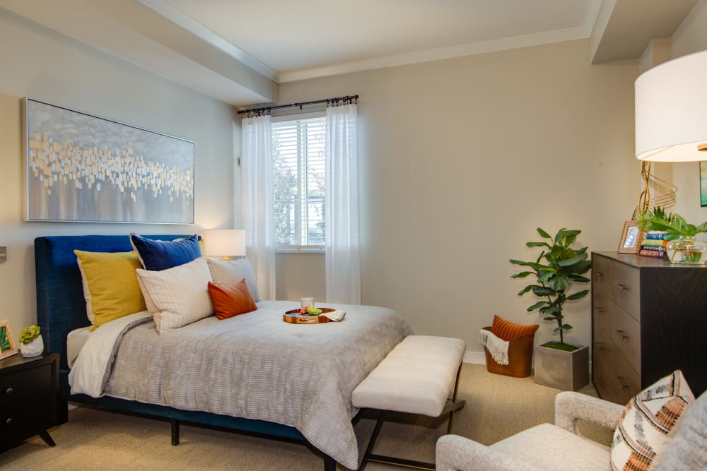 Modern brightly lit bedroom in senior living apartment at Sage Glendale in Glendale, California