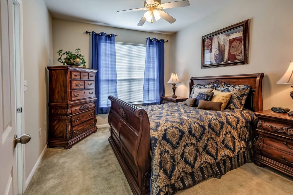 Spacious model bedroom with plush carpeting at Chateau des Lions Apartment Homes in Lafayette, Louisiana