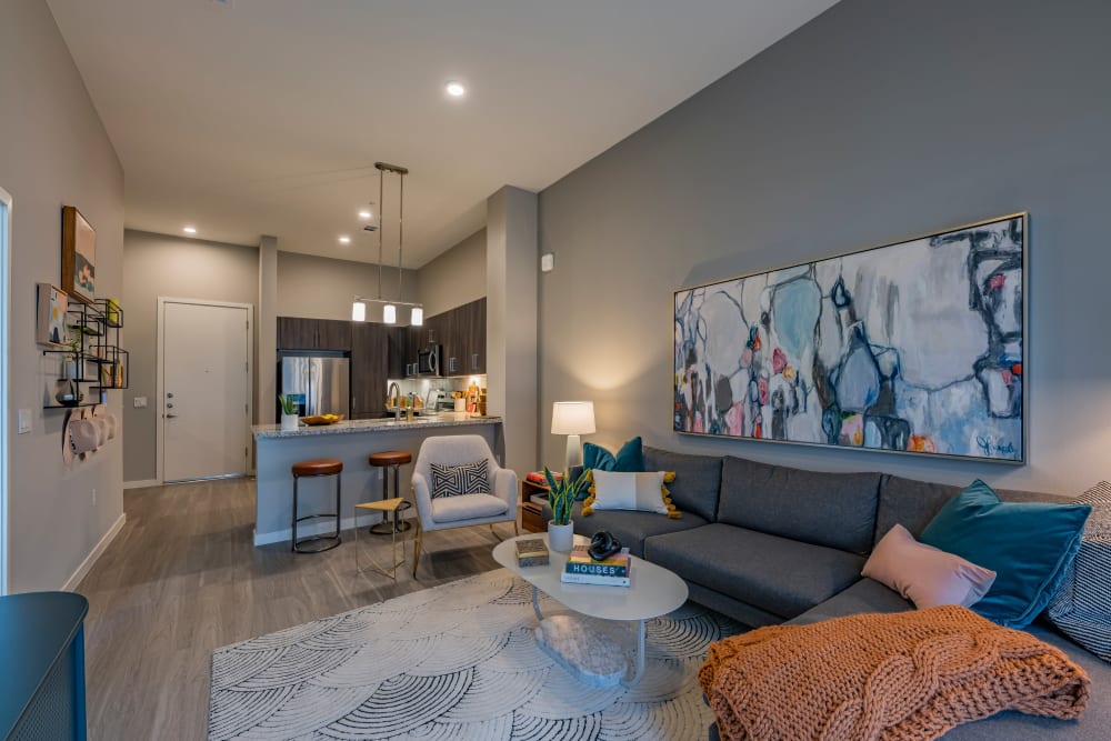 Living room with wood style flooring at Encore Tessera in Phoenix, Arizona