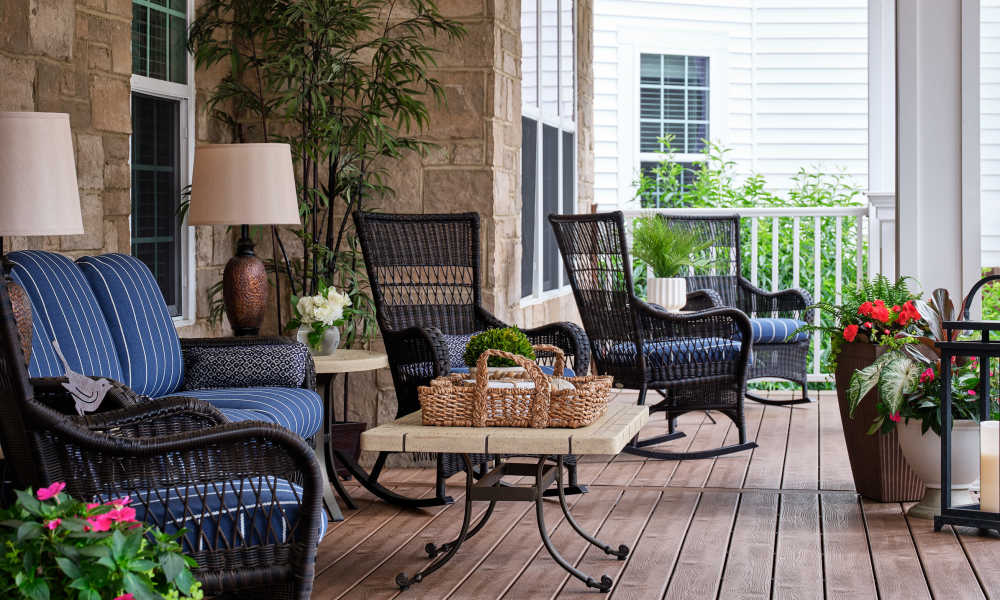 Covered outdoor patio with seating and garden views at Waltonwood Cotswold in Charlotte, North Carolina  
