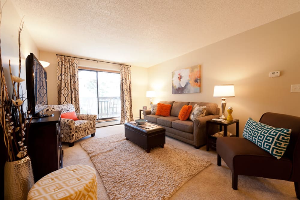 Beautiful living room with lots of natural lighting at Pointe West Apartment Homes in West Des Moines, Iowa