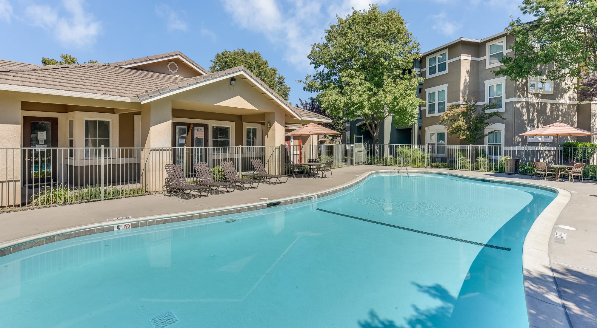 Natomas Park Apartments features a relaxing pool and hot tub, in Sacramento, California