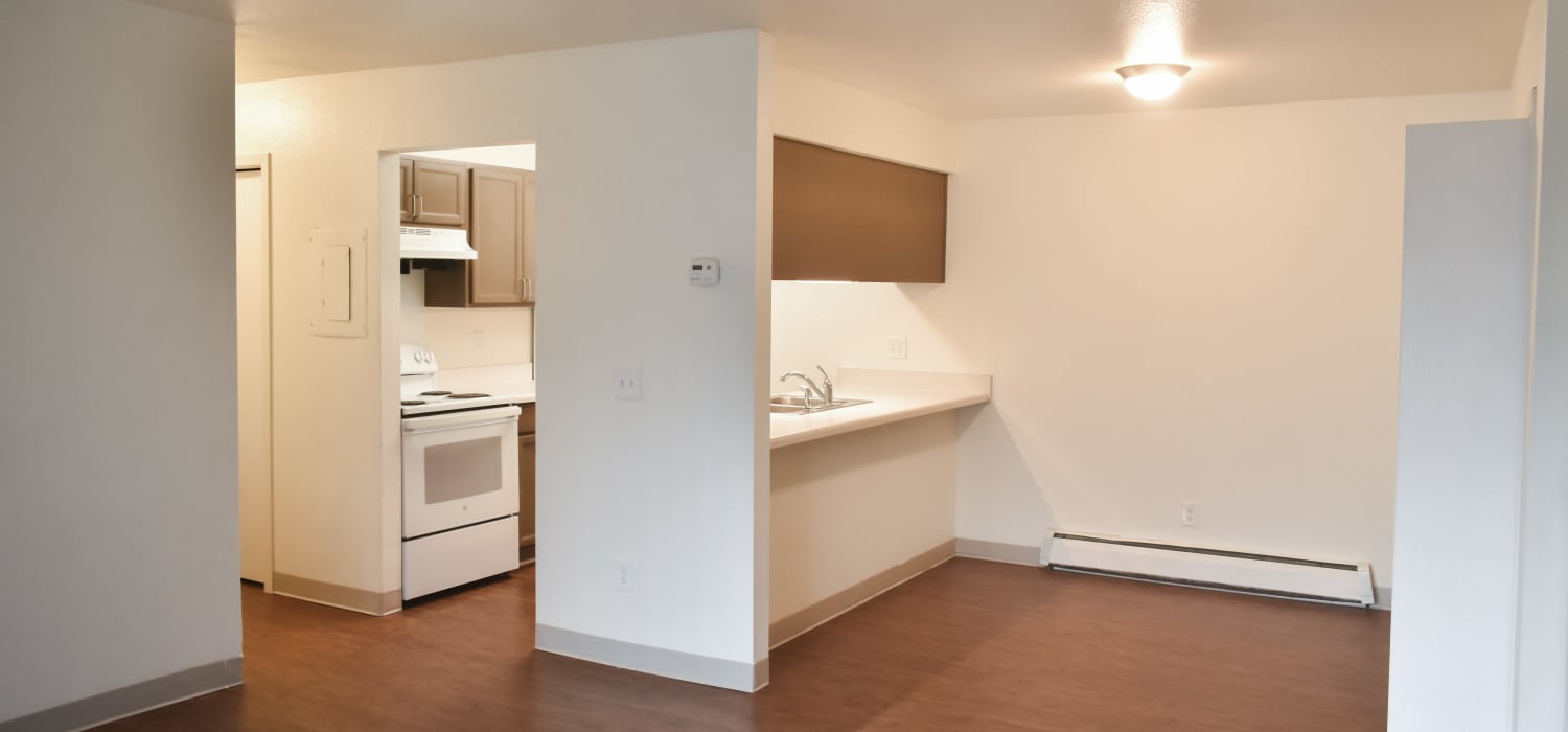 Unfurnished living room with connecting kitchen at Clairewood Apartments in Saint Clair, Michigan
