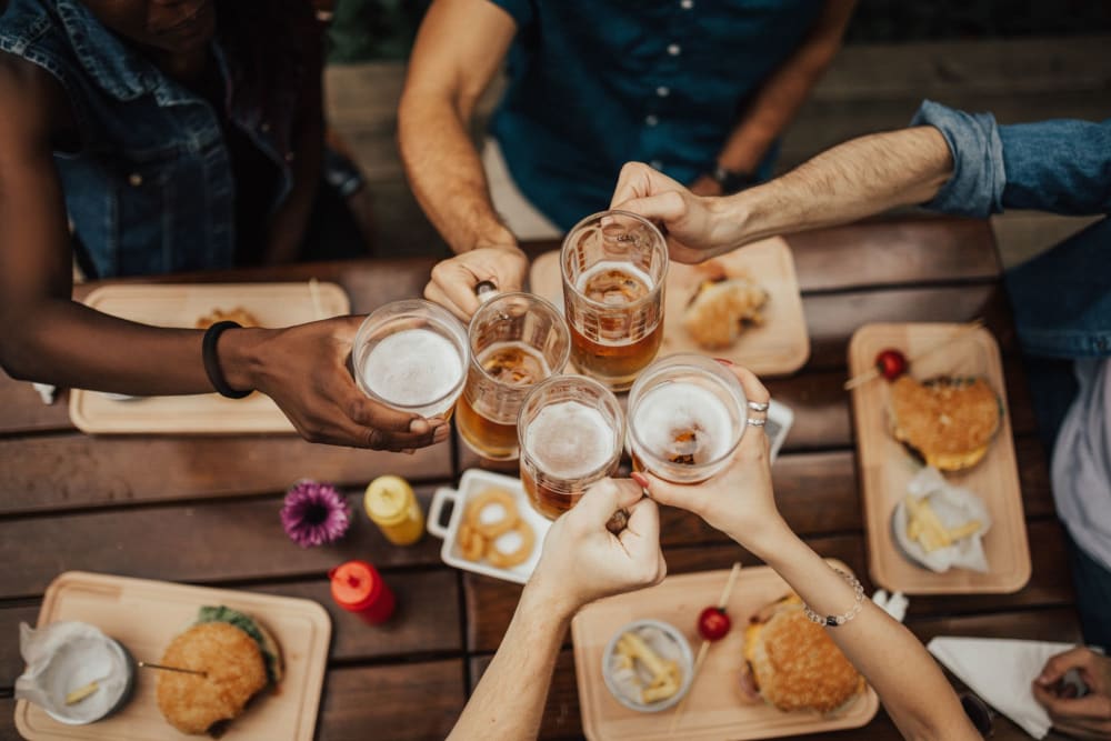 Residents enjoying their drinks at a nearby restaurant at The Courtyard Apartment Homes in Mukilteo, Washington