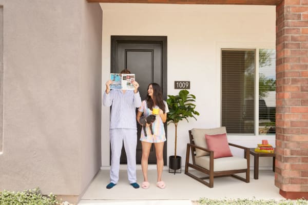 Couple on their door holding their pet at BB Living Union Park in Phoenix, Arizona