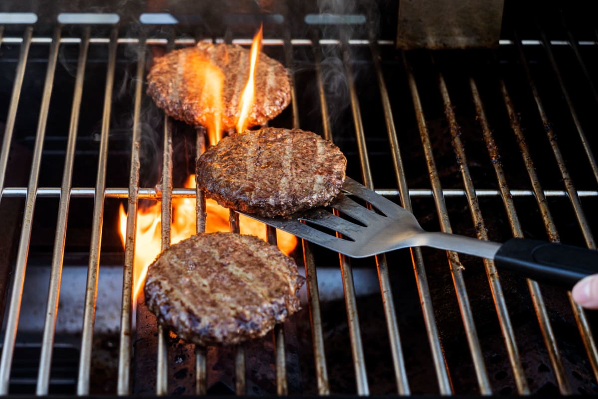 A resident grilling up a burger at Donovan Village in Houston, Texas