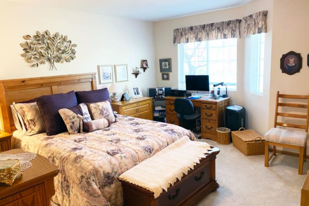 Serene bedroom in apartment of The Iris Senior Living in Great Falls, Montana. 